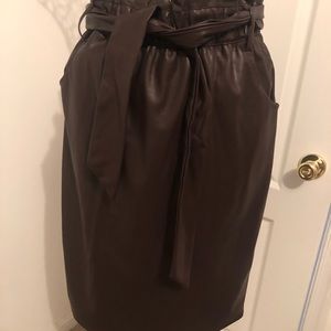 Dark chocolate faux leather pencil skirt with pocket and belt.